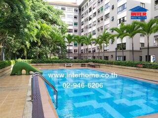 Outdoor swimming pool area in a residential building complex