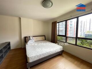 Bedroom with large window and city view