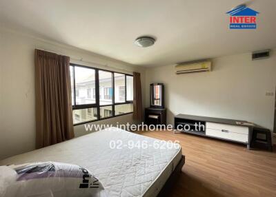 Spacious bedroom with large windows