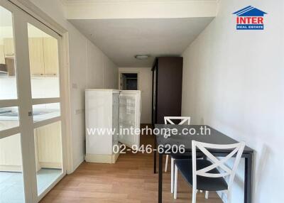 Small dining area with table and chairs adjacent to kitchen