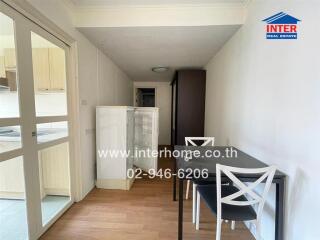 Small dining area with table and chairs adjacent to kitchen