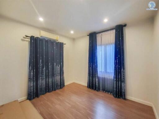 Bedroom with curtains and wooden floor