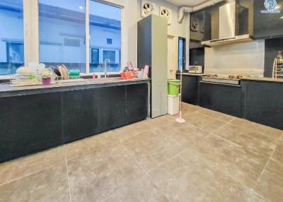 Modern kitchen with black cabinets and stainless steel appliances