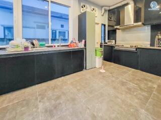 Modern kitchen with black cabinets and stainless steel appliances