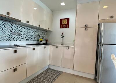 Modern kitchen with beige cabinets and stainless steel appliances