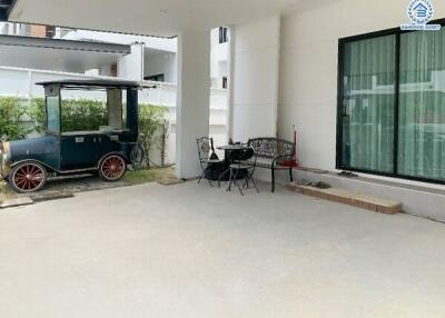 Outdoor patio area with seating and garden trolley