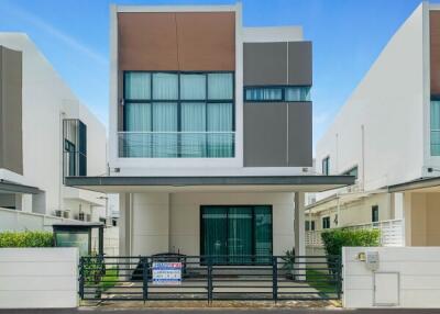 Front view of a modern two-story house with large windows