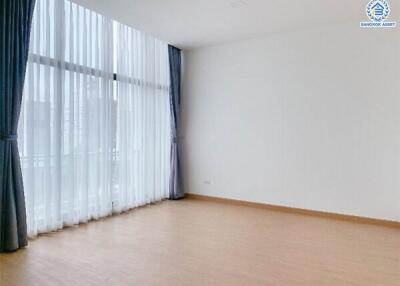 Spacious living room with large windows and natural light