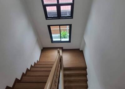 Interior view of a wooden staircase with a skylight