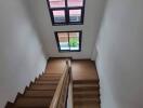 Interior view of a wooden staircase with a skylight