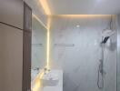 Modern bathroom with large mirror and illuminated vanity