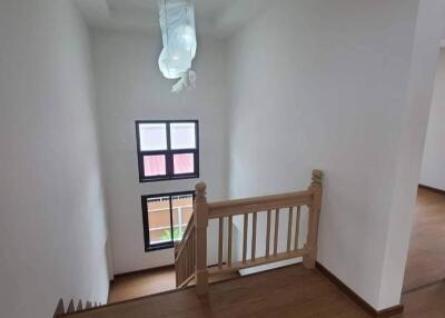 View of staircase and landing area with wooden flooring