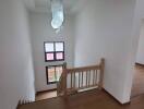 View of staircase and landing area with wooden flooring