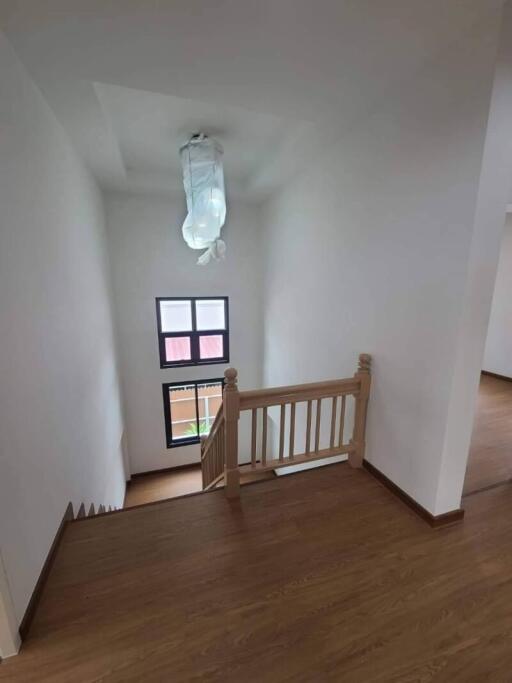 View of staircase and landing area with wooden flooring