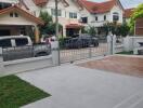 View of the front yard and the neighborhood with houses and parked cars