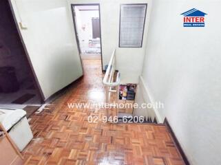 Staircase and hallway with polished wooden floor