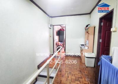 Hallway with parquet flooring and adjacent rooms