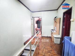 Hallway with parquet flooring and adjacent rooms