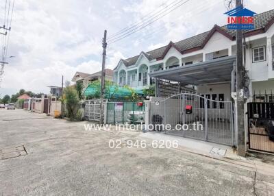 Exterior view of a residential building with a gated entrance