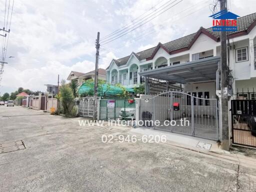 Exterior view of a residential building with a gated entrance