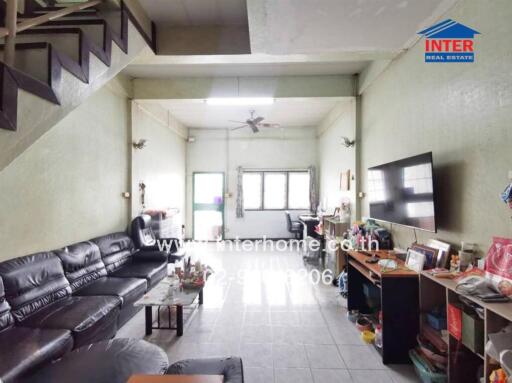 spacious living room with large TV and natural lighting