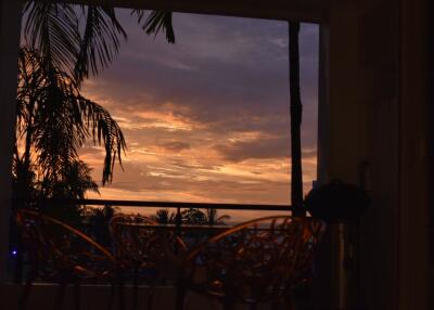 Sunset view from balcony with palm trees