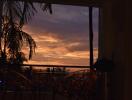 Sunset view from balcony with palm trees