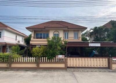 Exterior view of a two-story house with a fenced yard