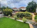 Well-maintained green garden with bushes and a view of the neighborhood