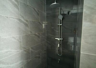 Shower area with tiled walls and modern shower fixture