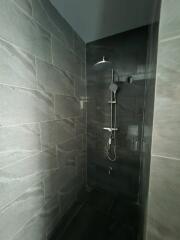 Shower area with tiled walls and modern shower fixture