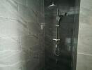 Shower area with tiled walls and modern shower fixture