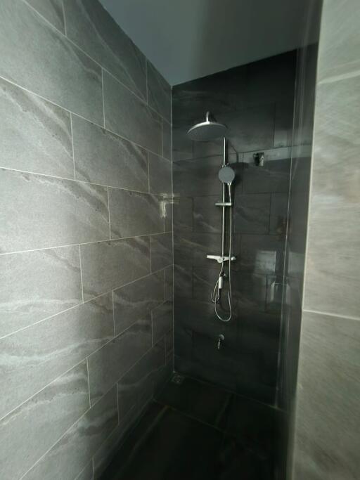 Shower area with tiled walls and modern shower fixture