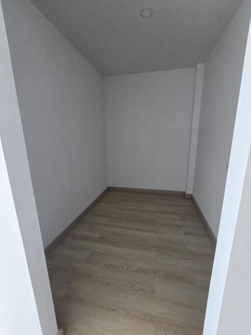 Empty small room with wooden floor