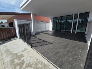 Outdoor patio with tiled flooring and glass sliding doors