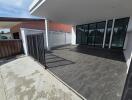 Outdoor patio with tiled flooring and glass sliding doors