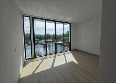 Spacious living room with large windows and natural lighting