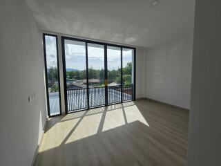 Spacious living room with large windows and natural lighting