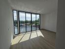 Spacious living room with large windows and natural lighting