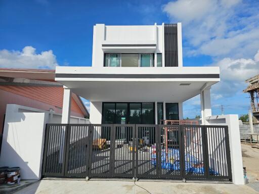 Front view of a modern house with a gated entrance