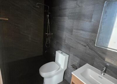 Modern bathroom with dark tiles