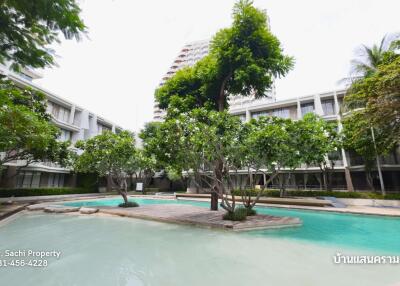 Pool area with lush trees and greenery