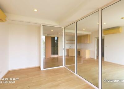 Spacious living area with large mirrors and sliding glass doors