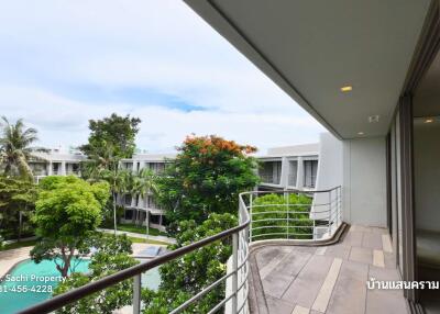 Balcony view of garden and pool area in a residential property