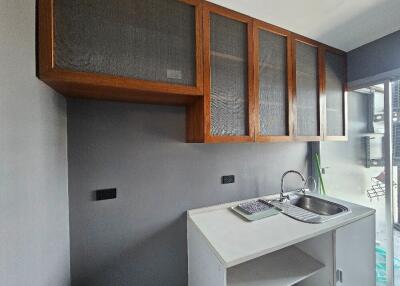 Modern kitchen with upper wooden cabinets and a sink