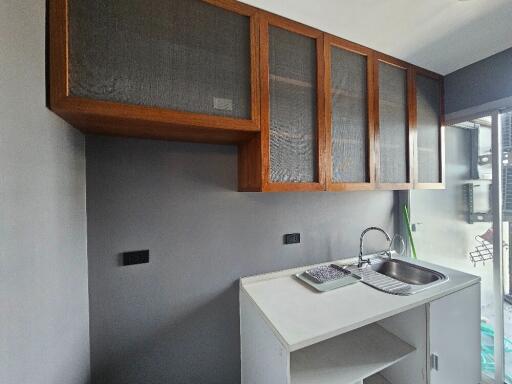 Modern kitchen with upper wooden cabinets and a sink