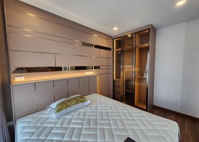 Modern bedroom with built-in wardrobe and stylish lighting