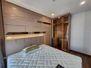 Modern bedroom with built-in wardrobe and stylish lighting