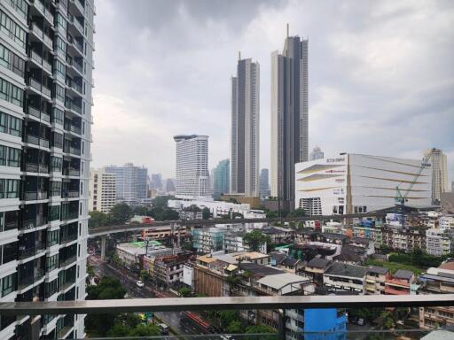 View from the balcony showing cityscape with tall buildings