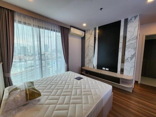 Modern bedroom with large window, air conditioner, and bed